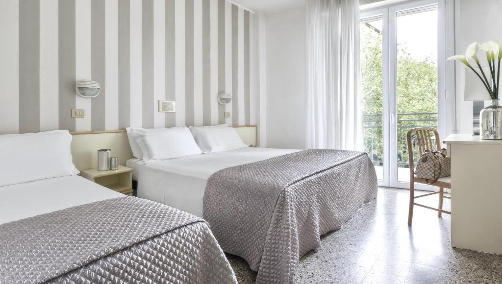 Postel nebo postele na pokoji v ubytování Hotel Carignano