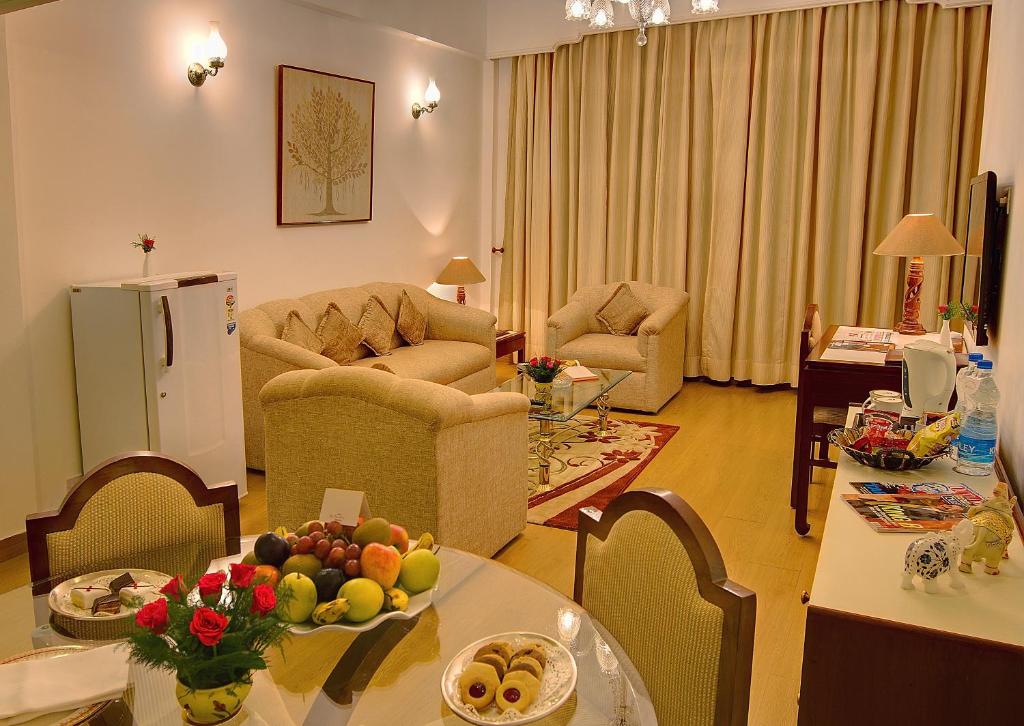 a living room with a table with fruit on it at Hotel Clarks Shiraz in Agra