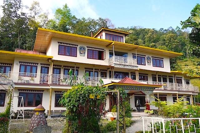 a large building with a lot of windows at Bamboo Retreat in Gangtok