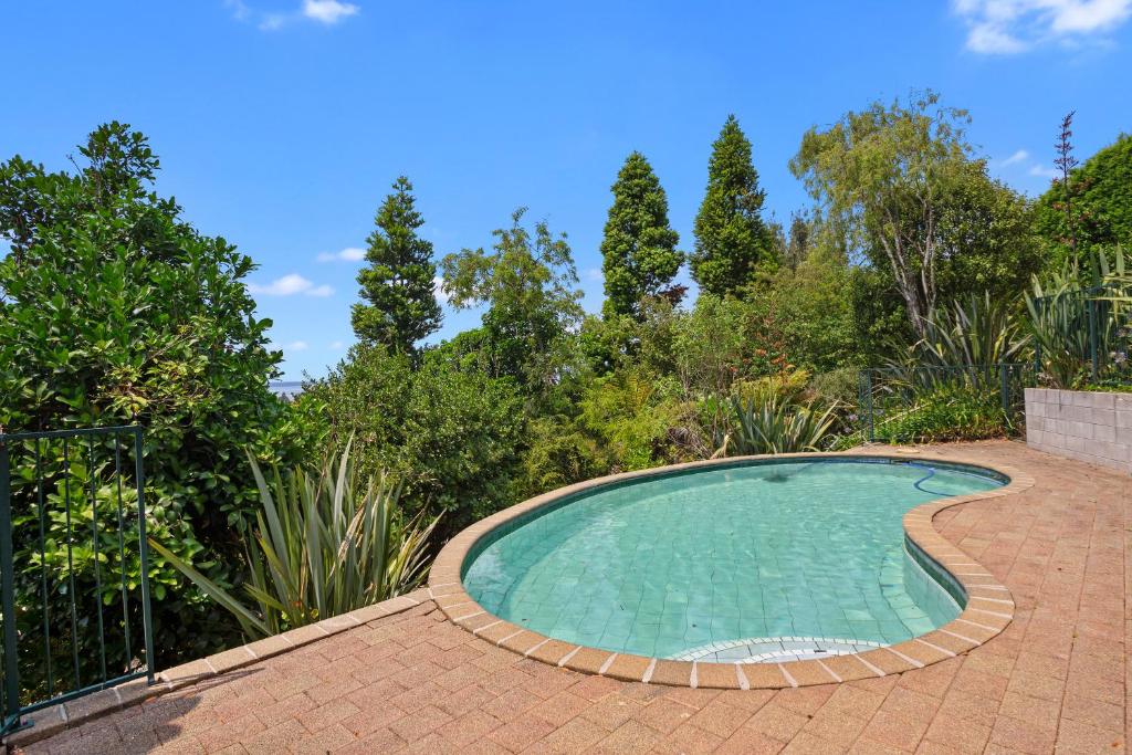 a small swimming pool on a brick patio at Country Retreat - Athenree Holiday Home in Waihi Beach