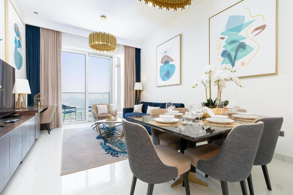 a dining room with a table and chairs at Ultimate Stay Avani next to Palm Jumeirah in Dubai
