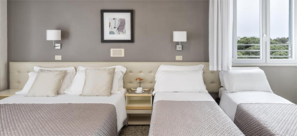 Postel nebo postele na pokoji v ubytování Hotel Carignano