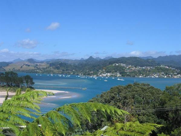 a view of a body of water with palm trees at The Great Escape - Tairua Holiday Home in Tairua