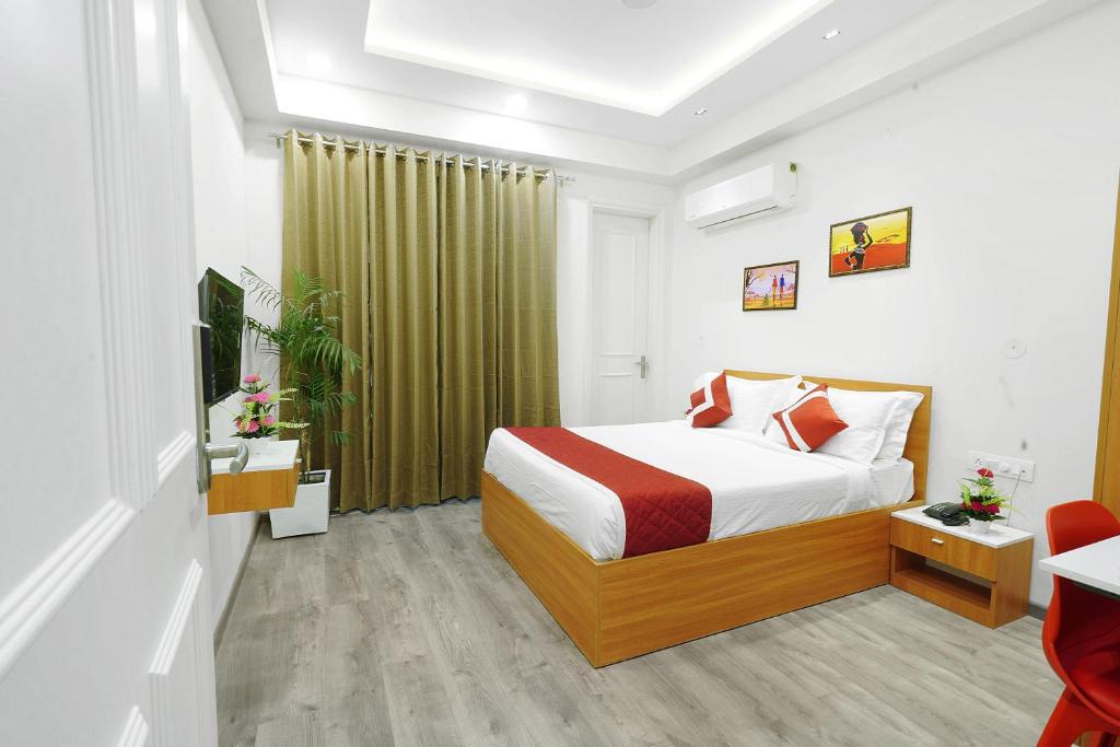 a bedroom with a bed and a green curtain at Octave Orchid Vista in Gurgaon