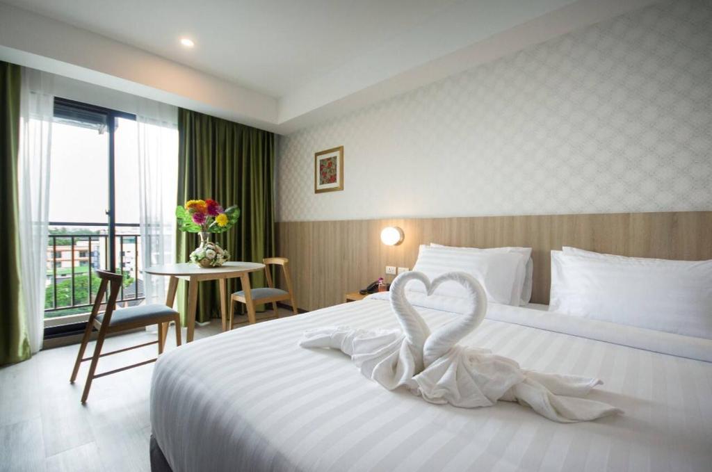 Postel nebo postele na pokoji v ubytování Marsi Hotel @ Bangchak