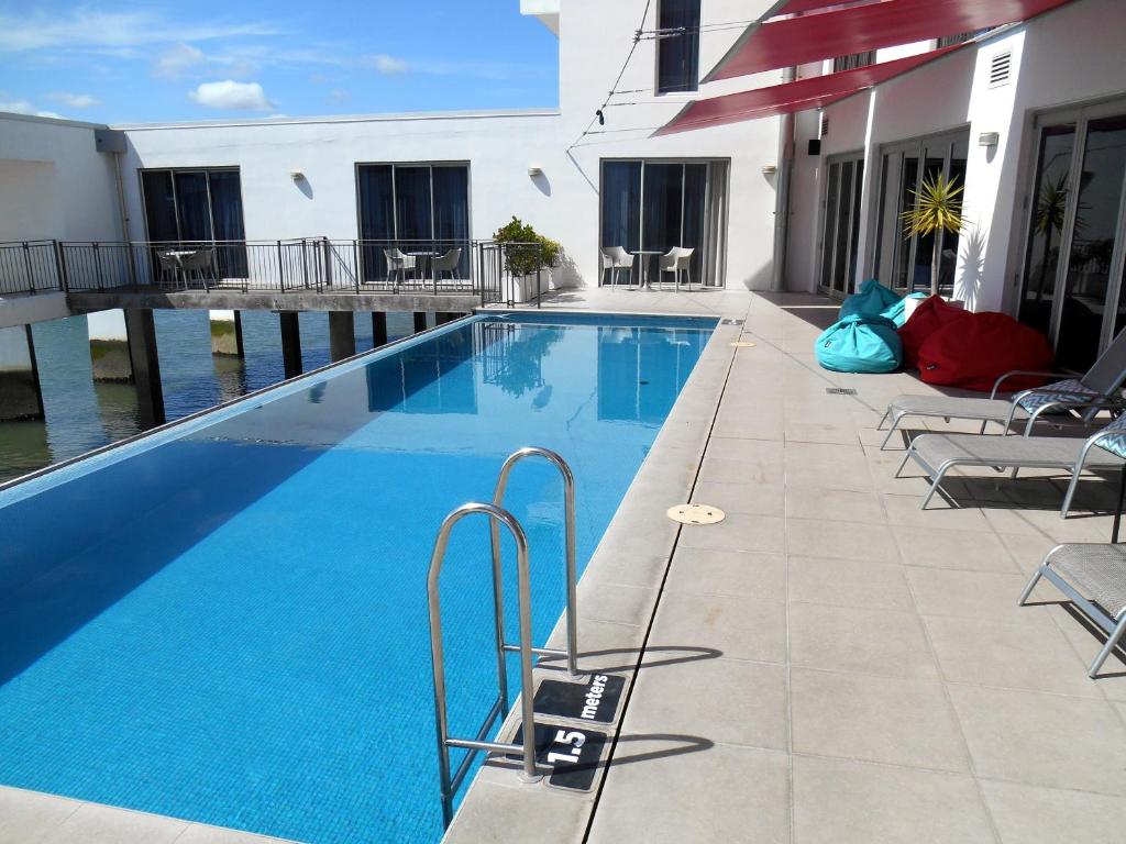 a swimming pool on the side of a building at Absolute Waterfront, Tauranga Apartment in Tauranga