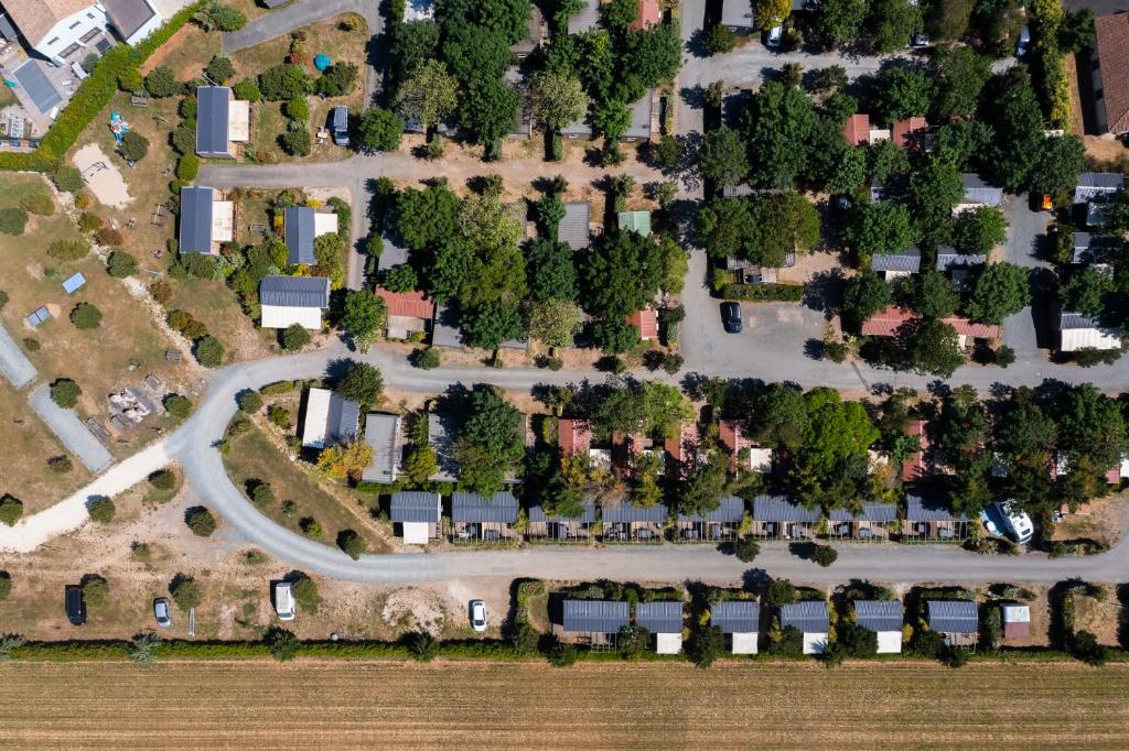 an overhead view of a park with trees and a road at Camping Paradis 4 étoiles Au Port de L'Houmeau - La Rochelle in LʼHoumeau