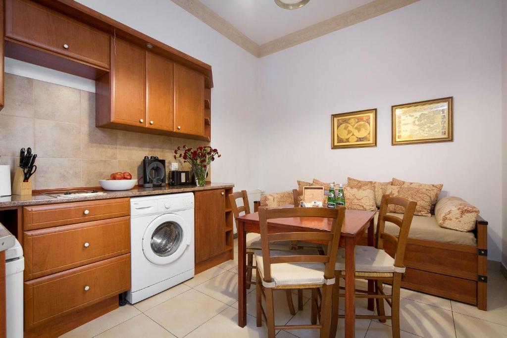 a kitchen with a table and a washing machine at B12 - Comfort Apartemnts City Center in Krakow