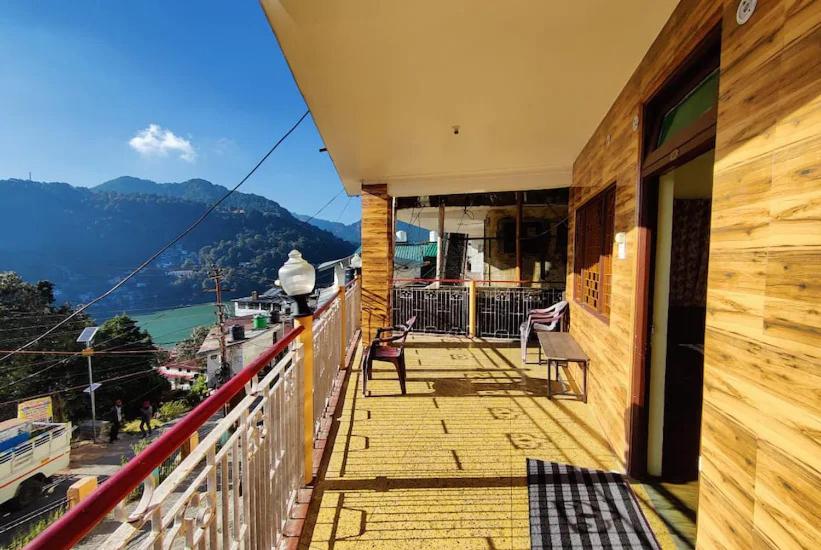 a balcony of a house with a view of a mountain at Hotel Surya Lake view in Nainital
