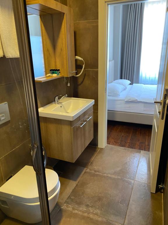 a bathroom with a sink and a toilet and a window at Eleven Aparts in Istanbul