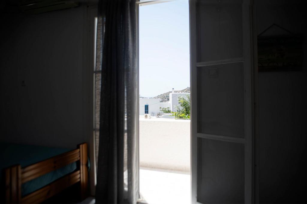 an open door to a room with a window at Ios Penelope in Ios Chora