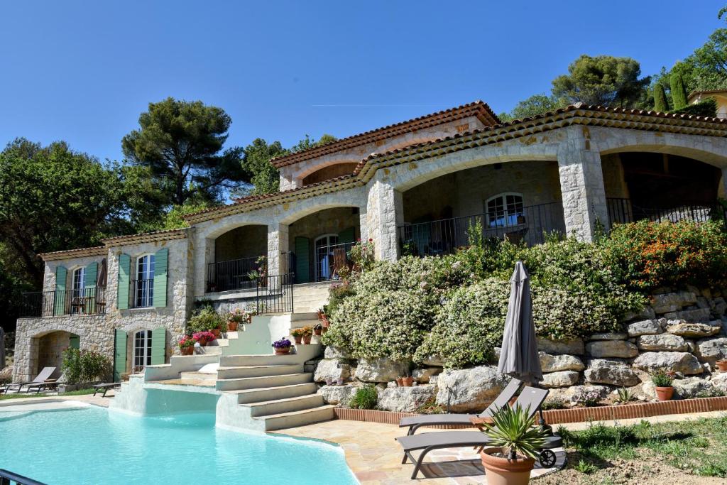 a house with a swimming pool in front of it at Chambre d'hôtes Cottes in Callian