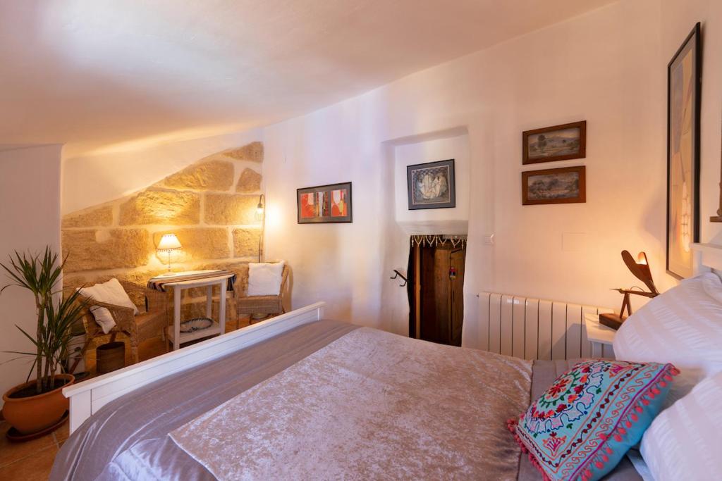 a bedroom with a bed and a fireplace at Atelier 88 Boutique B&B in Alcalá la Real