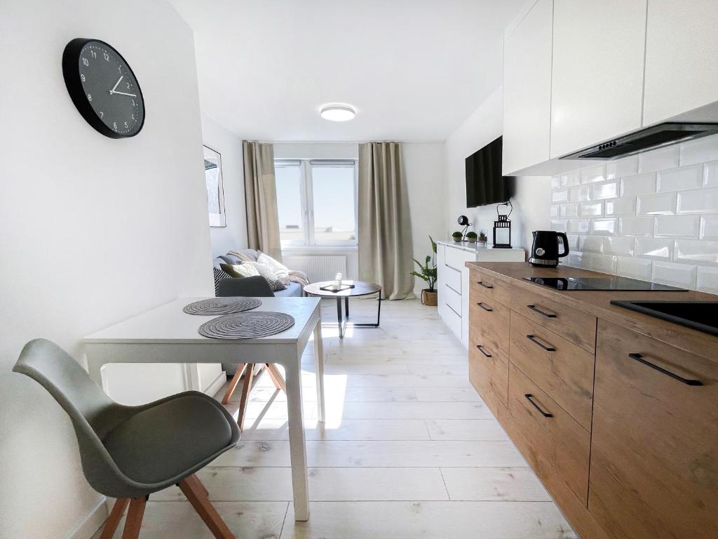 a kitchen with a table and a dining room at Przytulny apartament 500m od morza. in Gdańsk