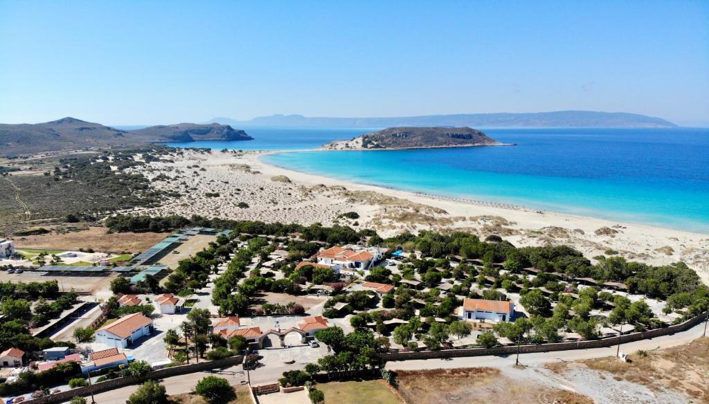 an aerial view of a beach with houses and the ocean at Simos Camping Elafonisos & Bungalows in Elafonisos