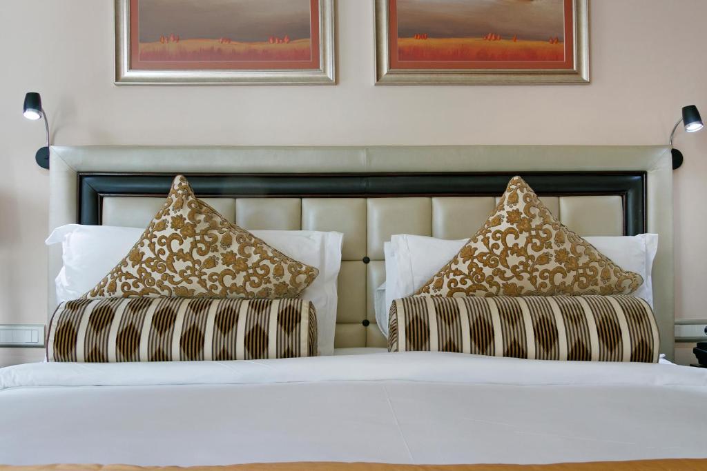 a bedroom with two beds with pillows on them at Taj Executive Suites, Private Residence in Cape Town