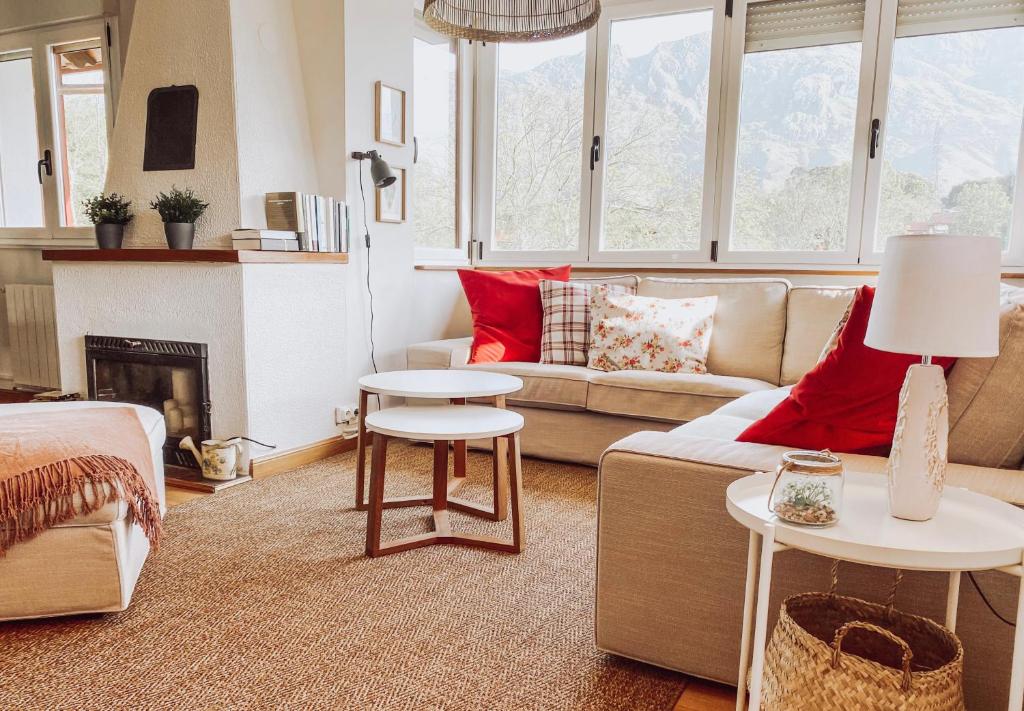 uma sala de estar com um sofá e uma lareira em Bella Kalma, acogedora casa con parking, jardin y wifi em Llanes