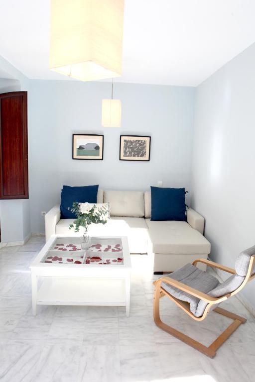 a living room with a white couch and a coffee table at Sleepin Sevilla in Seville