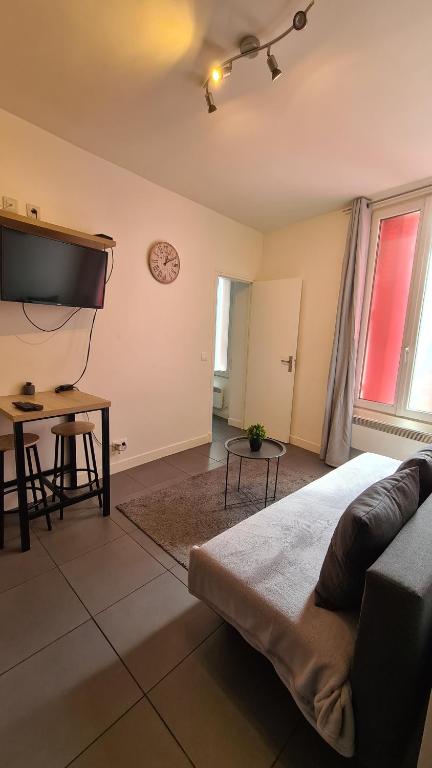 una camera con letto e TV a schermo piatto di Logesty Home proche Paris et Metro a Pantin