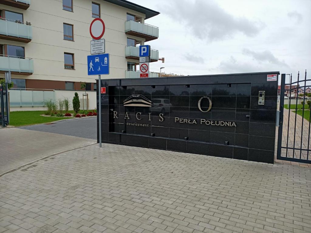 a building with a sign in front of a building at Apartament PERŁA POŁUDNIA in Suwałki