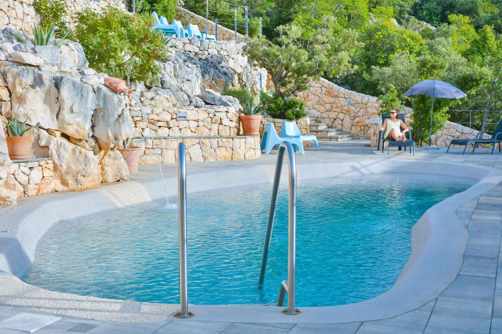 a swimming pool in the middle of a resort at Apartments Miki in Donja Klada