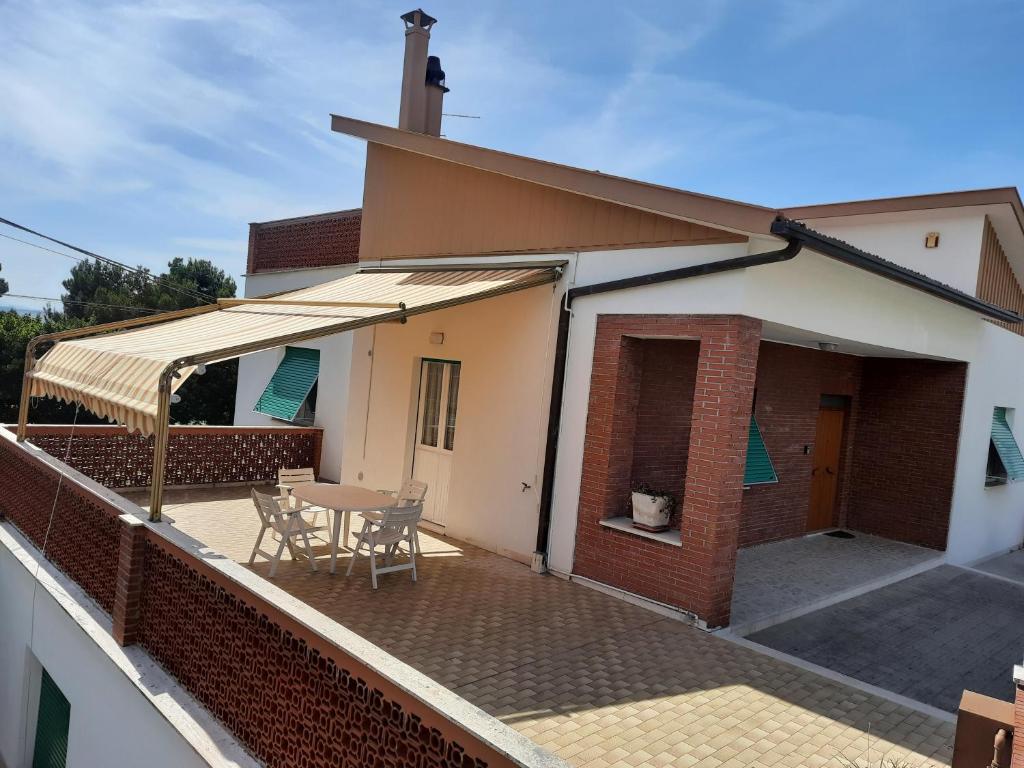 a patio with a table and chairs on a roof at RESIDENCE ACCORDEON in Castelfidardo