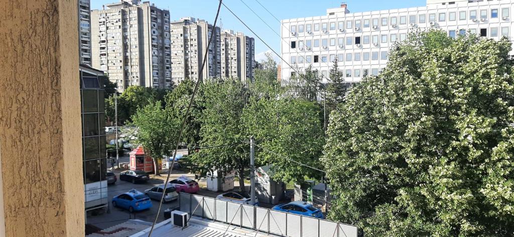 a view of a city with cars parked in a parking lot at Greenspace in Niš