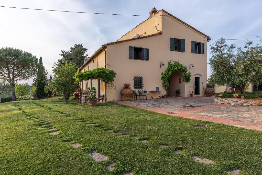 an exterior view of a house with a yard at Il Torriano in Montefiridolfi