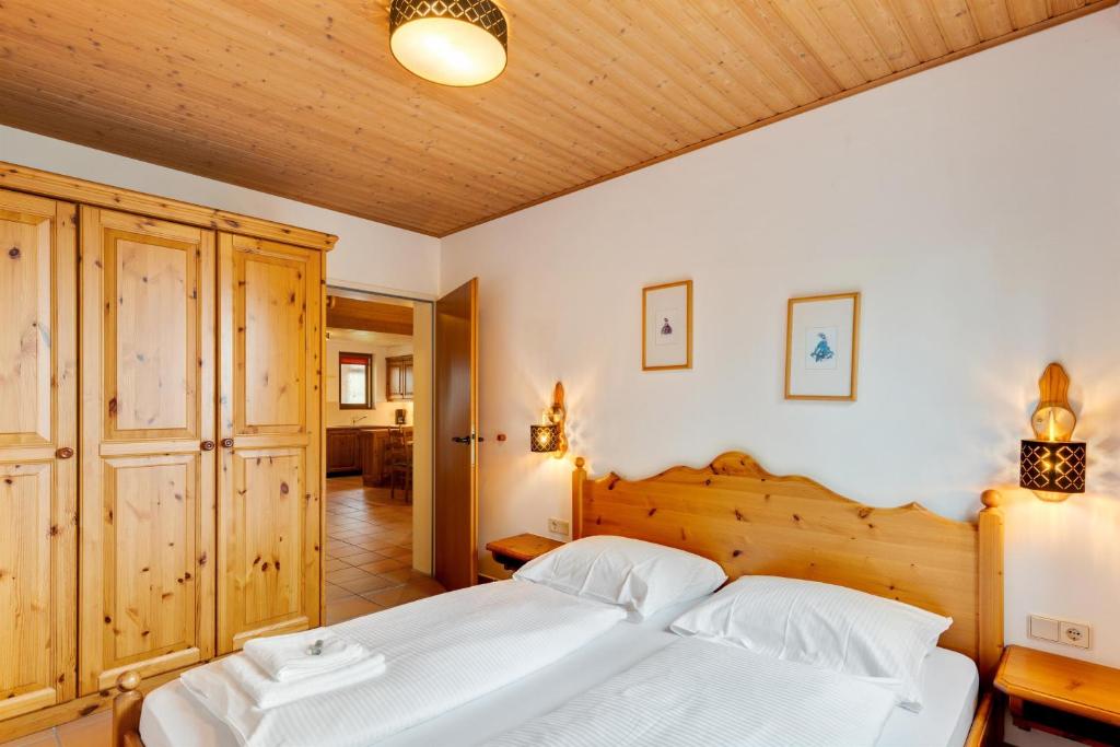 1 dormitorio con cama blanca grande y techo de madera en 4 Jahreszeiten Destination Treffen, en Treffen
