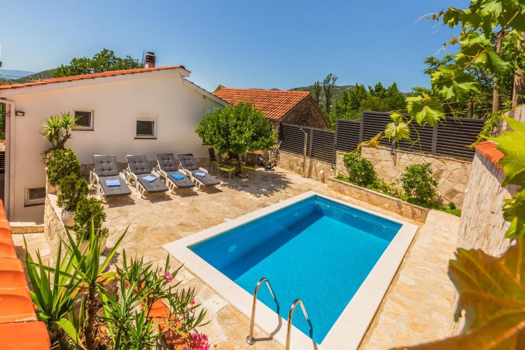 a pool in the backyard of a house at Villa Tina in Ploče