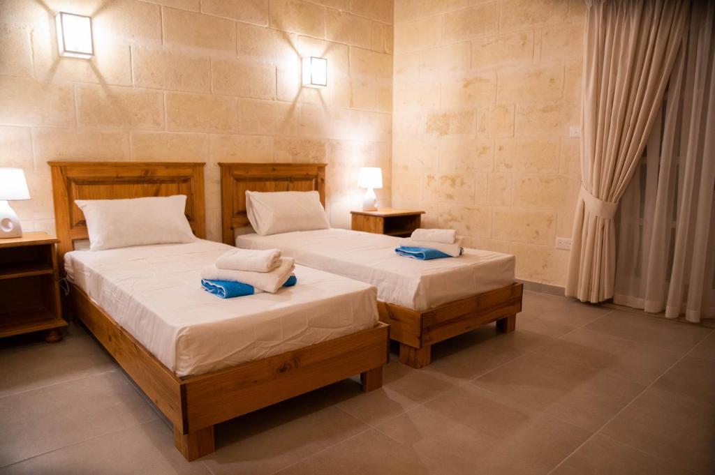 Postel nebo postele na pokoji v ubytování Ta' Giga Farmhouse