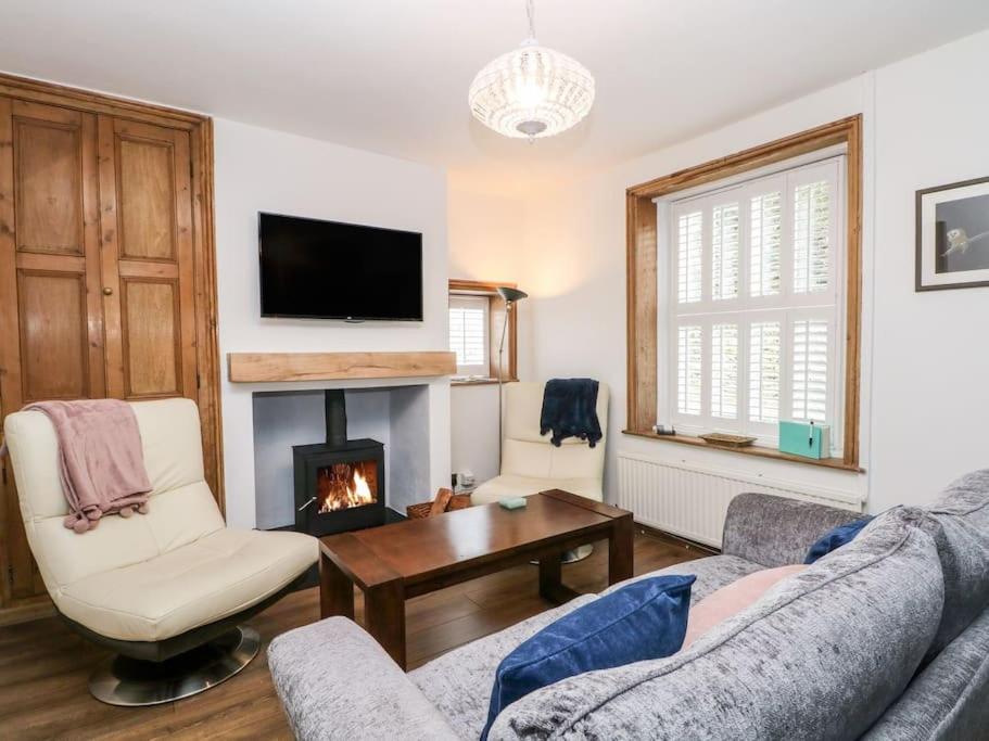 a living room with a couch and a fireplace at North View Cottage - Log burner,Views,Parking,walks,Peak District,Dogs in Rainow
