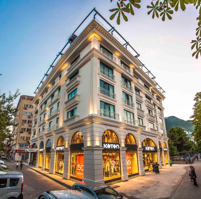 a large white building on a city street at Sinema Hotel Ordu in Ordu