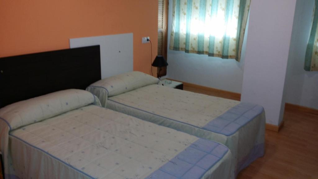 Posteľ alebo postele v izbe v ubytovaní Hotel Mesón El Número Uno