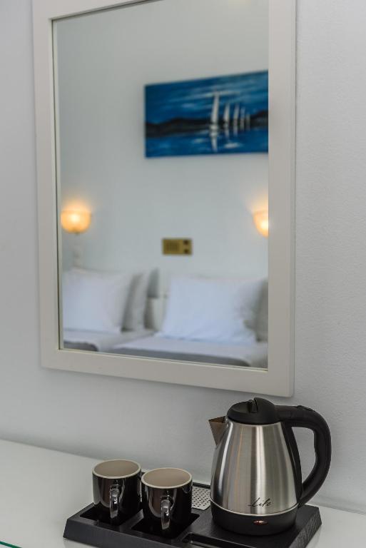 Postel nebo postele na pokoji v ubytování Glaros Hotel