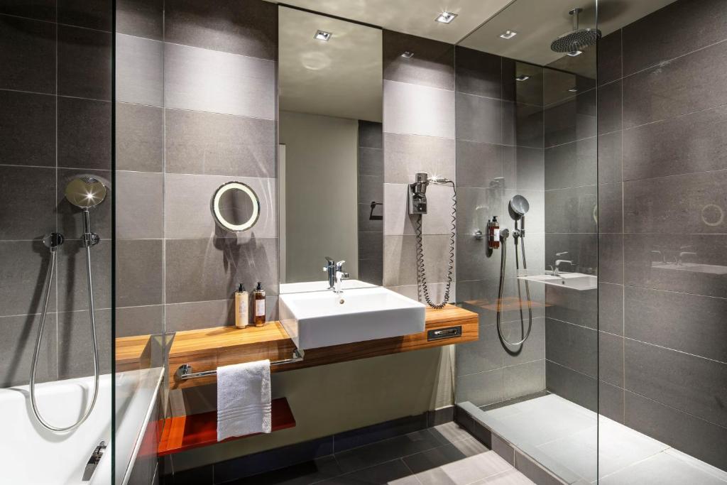 a bathroom with a sink and a shower at Clarion Congress Hotel Bratislava in Bratislava