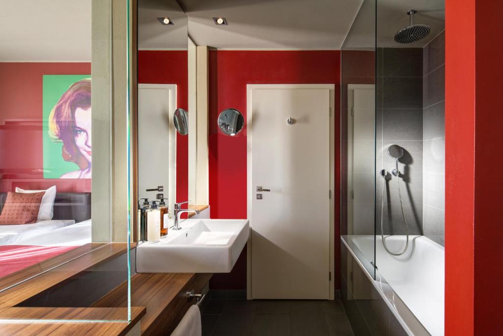 a bathroom with a sink and a shower at Clarion Congress Hotel Bratislava in Bratislava