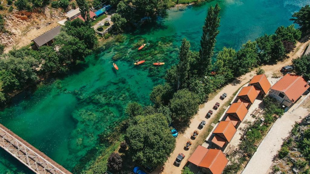 an aerial view of a river with people swimming in it at River huts Zrmanja in Obrovac