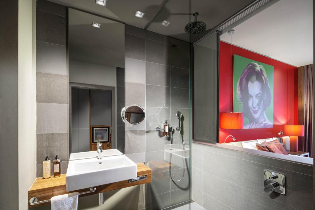 a bathroom with a sink and a shower at Clarion Congress Hotel Bratislava in Bratislava