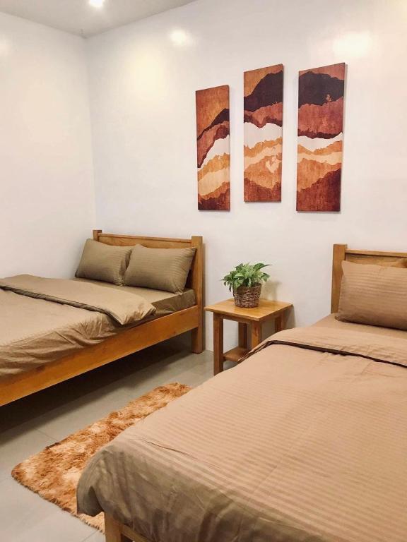 Postel nebo postele na pokoji v ubytování Nord House Laoag