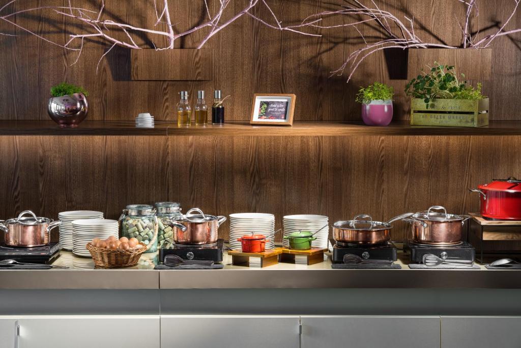 a counter with pots and pans and dishes on it at Clarion Congress Hotel Bratislava in Bratislava