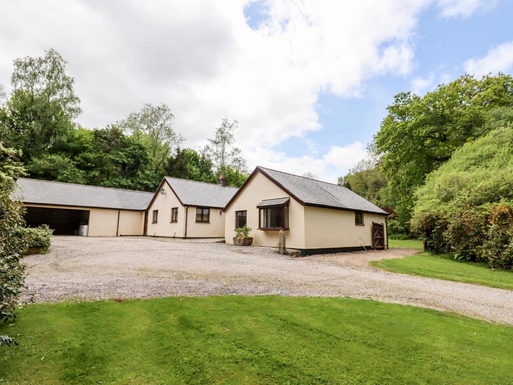a detached house with a garage and a driveway at Woodlands in Okehampton