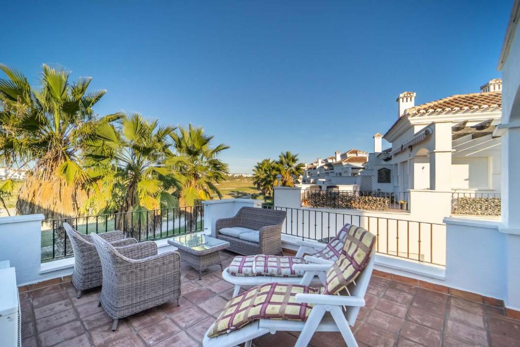 a patio with chairs and tables on a balcony at Stunning 2 Bedroom 2 Bathroom Town House - CE7LT in Roldán