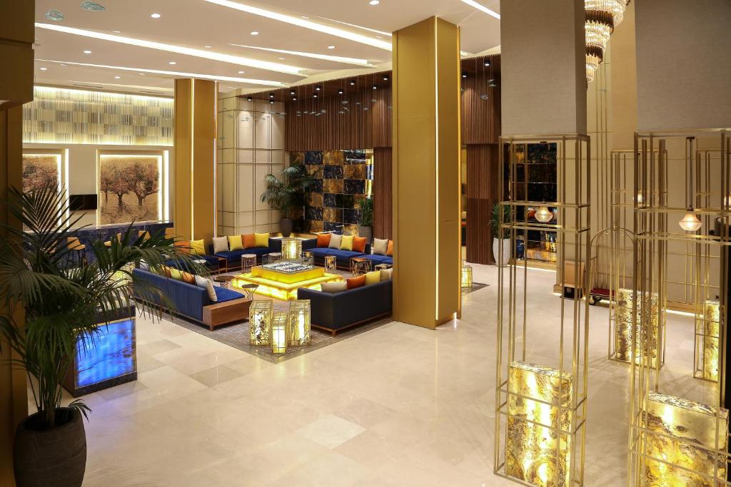 a lobby of a hotel with couches and tables at Oriental Palace by Agora Complex in Taza