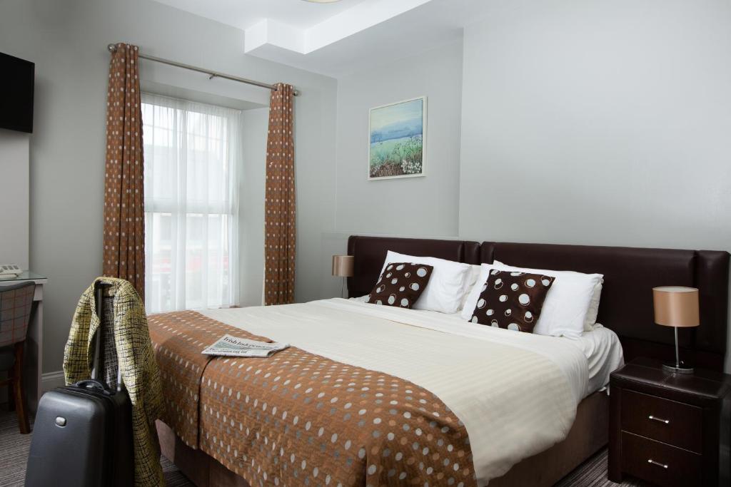 a bedroom with a large bed and a window at Mulcahys in Clonmel