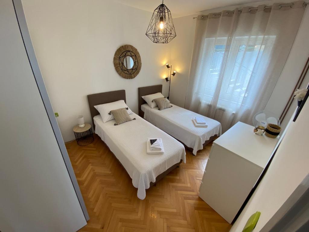 Postel nebo postele na pokoji v ubytování Apartman Betty