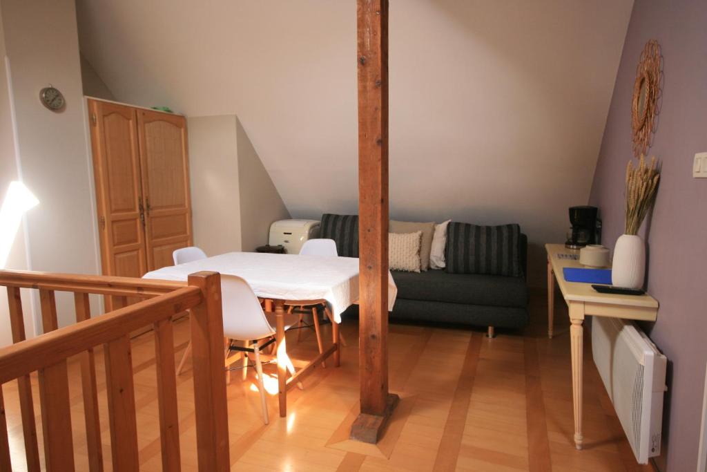 a living room with a table and a couch at Appartement Rapp in Colmar