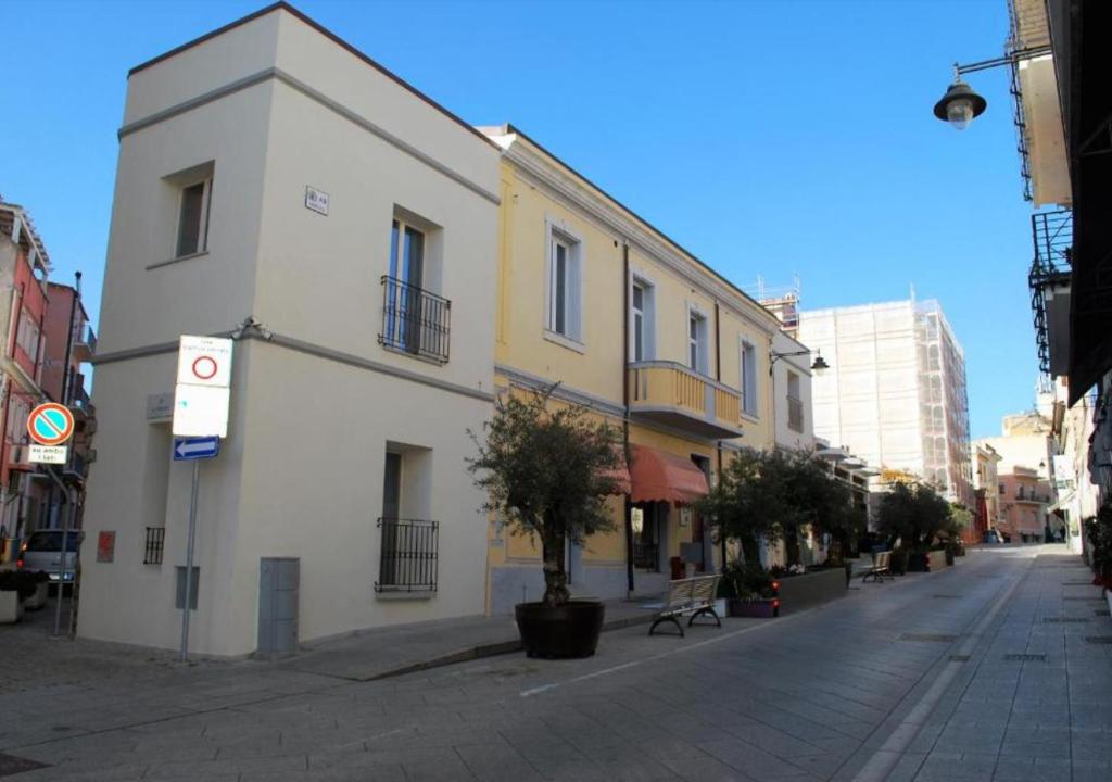 a building on a street in a city at Tabula Apartments in Olbia