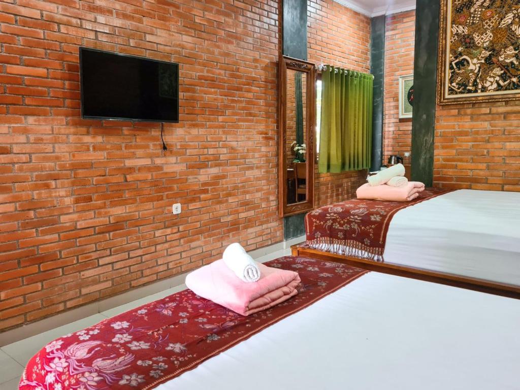 Postel nebo postele na pokoji v ubytování Ndalem Suryo Saptono Guest House