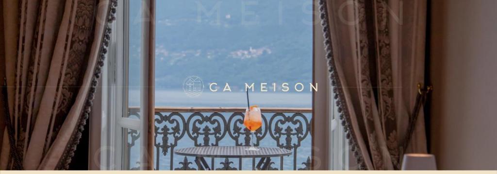 a window with a table and a view of the ocean at Ca Meison in Cannobio